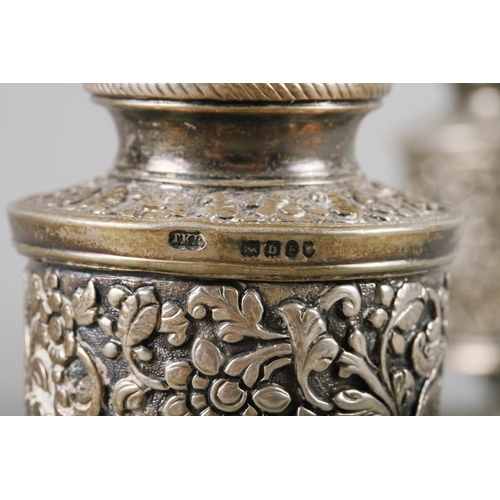 230 - A pair of silver gilt pedestal pepper pots with engraved floral decoration, 3 3/8