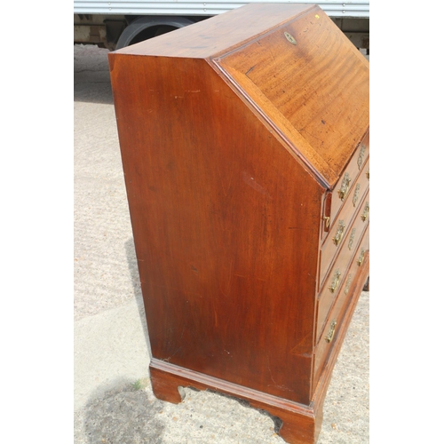 399 - A Georgian mahogany fall front bureau with fitted interior, over four long graduated drawers with pi... 