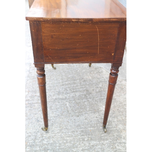 410 - A William IV mahogany kneehole desk/dressing table, fitted two deep and one shallow drawer, on turne... 