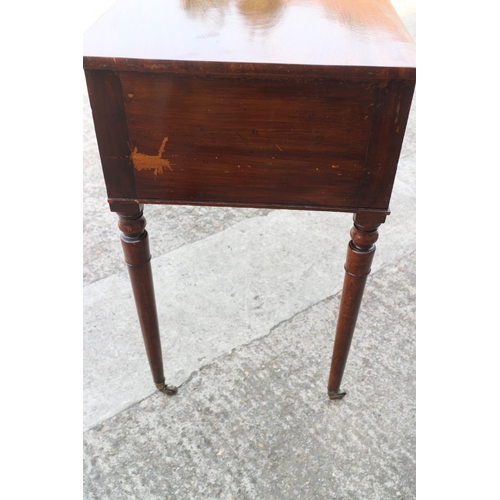 410 - A William IV mahogany kneehole desk/dressing table, fitted two deep and one shallow drawer, on turne... 