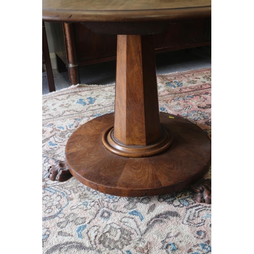 420 - A mid 19th century mahogany circular tilt top table, on faceted column and circular base with lion p... 