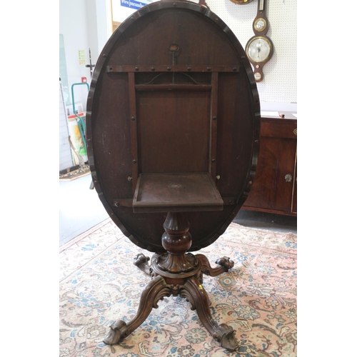 421 - A mid Victorian figured walnut oval loo table, on carved column and four scroll supports, 58