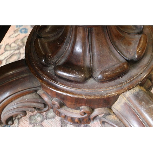 421 - A mid Victorian figured walnut oval loo table, on carved column and four scroll supports, 58