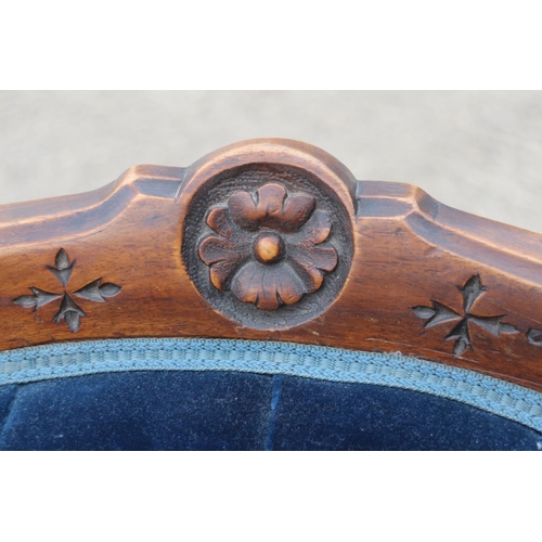 434 - A 19th century mahogany showframe chair, button upholstered in a blue velour, on cabriole supports