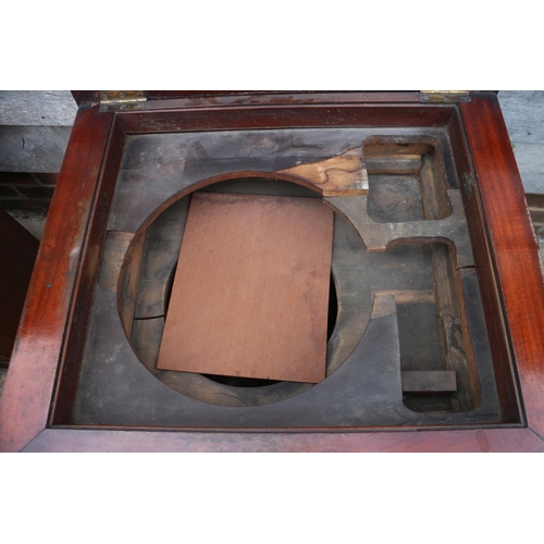 436 - A 19th century carved walnut washstand, formed as a column with Ionic capital lift up lid, on square... 