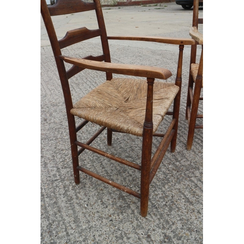 448 - A pair of Arts & Crafts chestnut ash ladder back elbow chairs with rush envelope seats