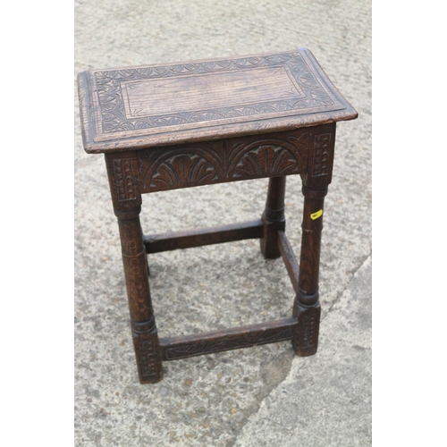 454 - An antique carved oak joint stool of 17th century design with carved decoration, on turned supports,... 