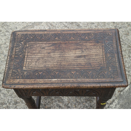 454 - An antique carved oak joint stool of 17th century design with carved decoration, on turned supports,... 