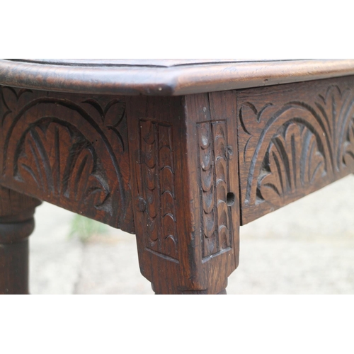 454 - An antique carved oak joint stool of 17th century design with carved decoration, on turned supports,... 