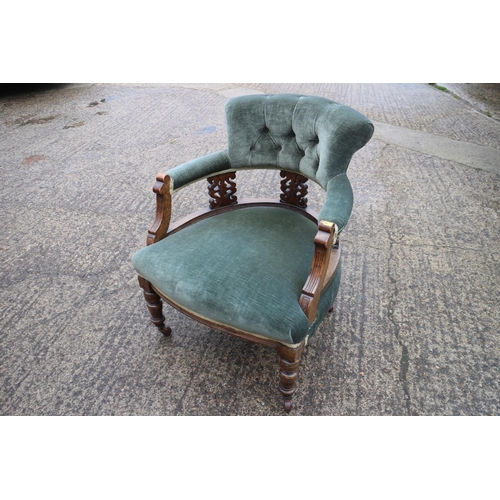 458 - A late Victorian carved walnut showframe splat back tub chair, upholstered in a green velour, on cas... 