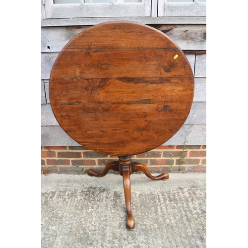 460 - An early 19th century oak provincial tilt top table, on birdcage, turned column and tripod splay sup... 