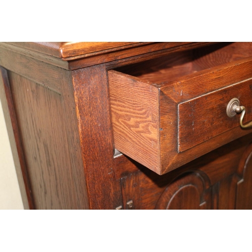 486 - An oak dresser, the upper section fitted two cupboards and open shelves, over three drawers and cupb... 