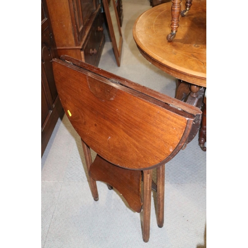 494 - A 1930s walnut folding two-tier occasional table, on turned and shaped supports, 23 1/2