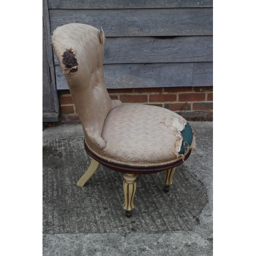 497 - A cream spoon back revolving occasional chair, upholstered in a cream floral fabric, on fluted suppo... 