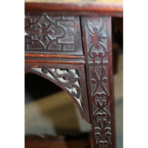 506 - An Edwardian carved mahogany fold-over patience table, on splay supports, united by a galleried unde... 