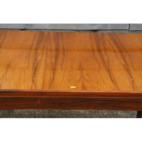 511 - A 1960s Danish rosewood dining suite comprising table, on moulded supports, 59