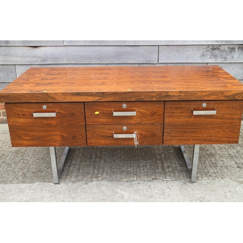 512 - A 1960s Danish rosewood desk, fitted deep drawers, on chrome supports, 62