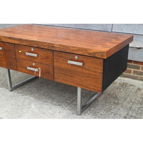 512 - A 1960s Danish rosewood desk, fitted deep drawers, on chrome supports, 62