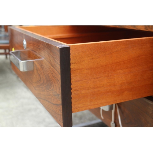 512 - A 1960s Danish rosewood desk, fitted deep drawers, on chrome supports, 62