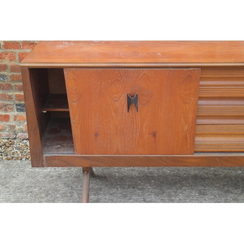 514 - A 1960s EON teak sideboard, fitted cupboards and three drawers, on splay supports, 88