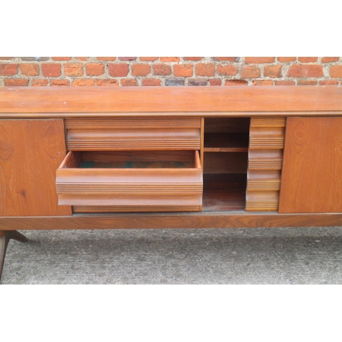 514 - A 1960s EON teak sideboard, fitted cupboards and three drawers, on splay supports, 88