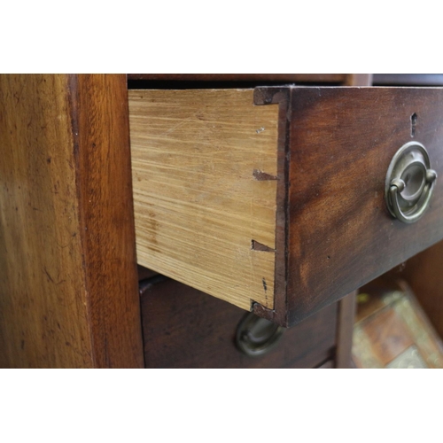 522 - An Edwardian mahogany kneehole desk with green leather lined top, over nine drawers with oval brass ... 