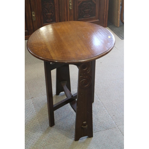 525 - A 1930s walnut circular fold-over top table, on panel end supports, 21