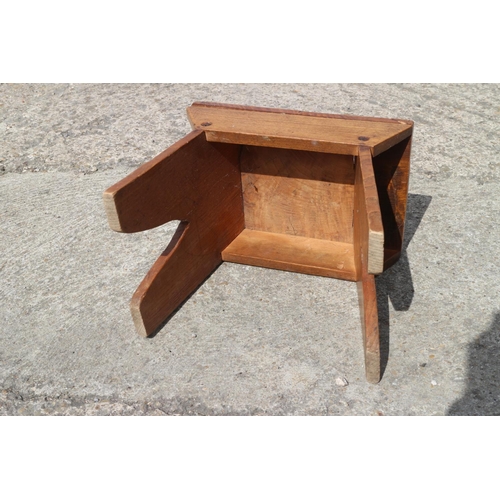 551 - An elm and fruitwood stool, on panel end supports, 10