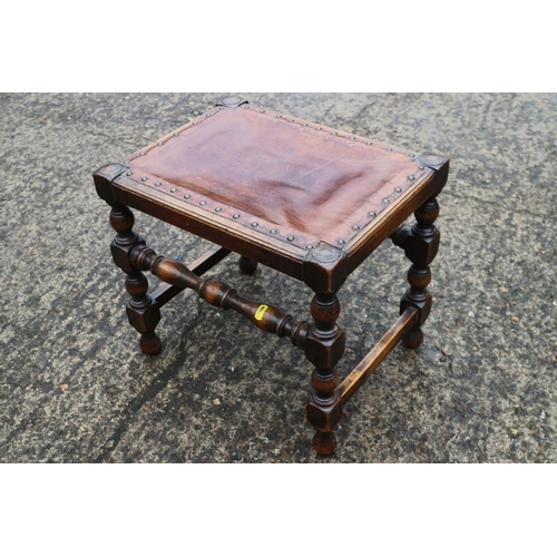 569 - A carved chestnut stool, on turned and stretchered supports, 12