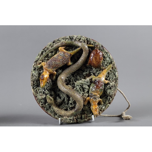 61 - A Palissy style circular dish, decorated snake, tortoise and crocodiles, 9