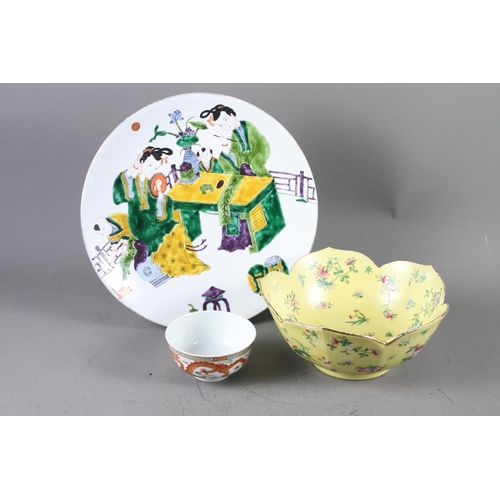 75 - A Chinese shaped rim bowl, decorated with flowers and fruit on a yellow ground with seal mark to bas... 