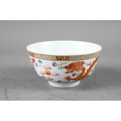 75 - A Chinese shaped rim bowl, decorated with flowers and fruit on a yellow ground with seal mark to bas... 