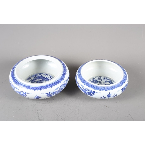 78 - A pair of Chinese blue and white dragon decorated porcelain stacking bowls, larger 9