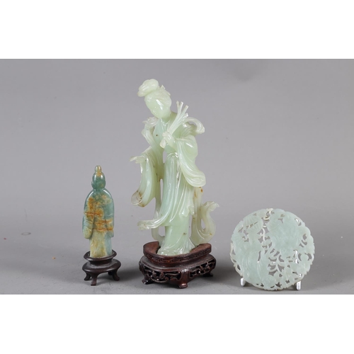 85 - A Chinese jade carving of Kuan-Yin, on wooden base, 8 1/2