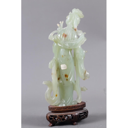 85 - A Chinese jade carving of Kuan-Yin, on wooden base, 8 1/2