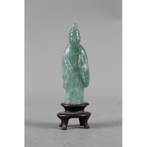 85 - A Chinese jade carving of Kuan-Yin, on wooden base, 8 1/2