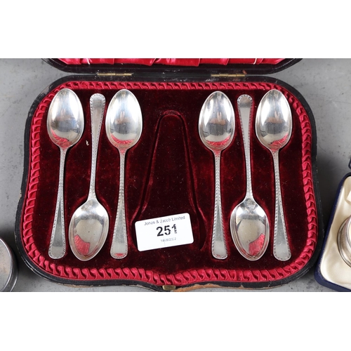 251 - A cased set of six feather edge silver teaspoons and two silver napkin rings