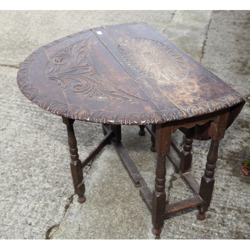 455 - An 18th century oak oval gateleg table with later carved decoration, on turned supports, 36