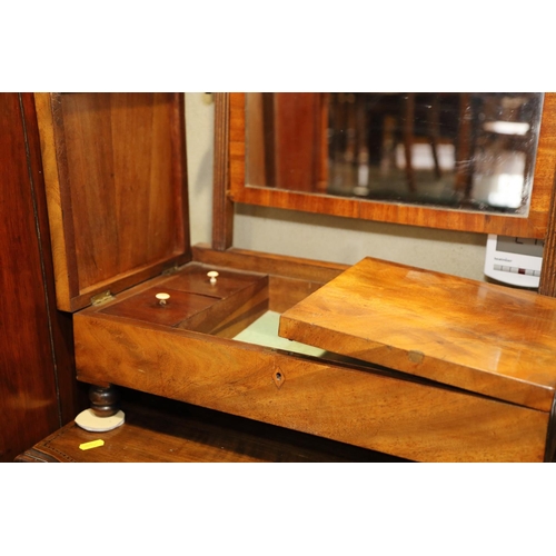 471 - A late Georgian figured mahogany toilet mirror with hinged based, fitted four compartments, on turne... 