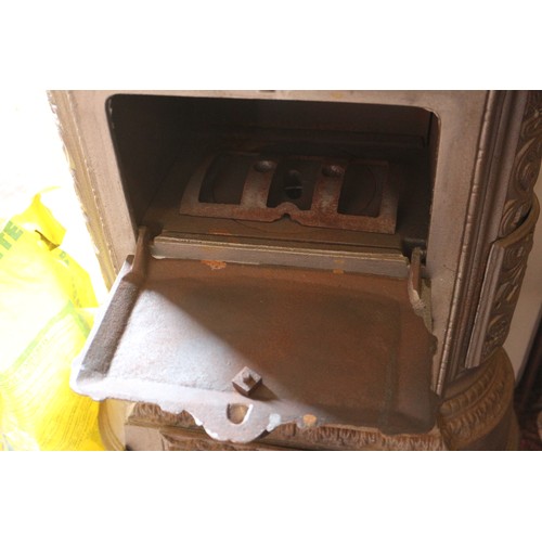 589 - A grey painted cast iron stove with pierced decoration, on cabriole supports, 19