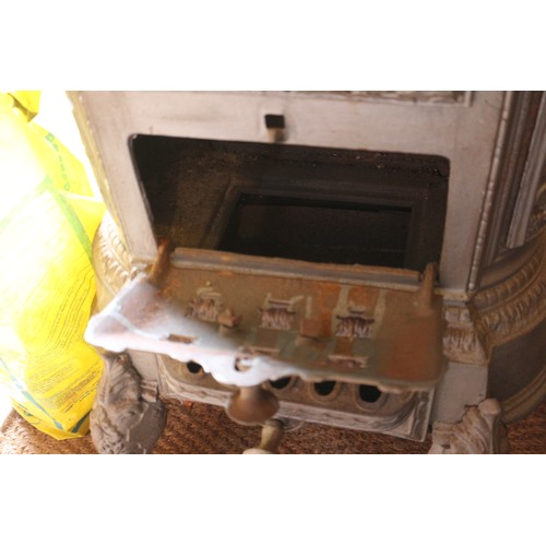 589 - A grey painted cast iron stove with pierced decoration, on cabriole supports, 19