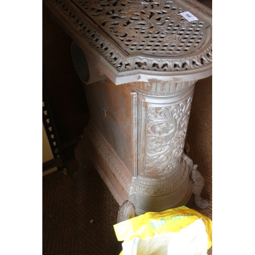 589 - A grey painted cast iron stove with pierced decoration, on cabriole supports, 19