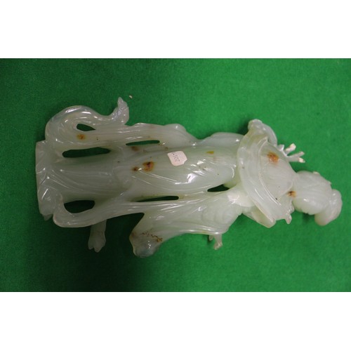 85 - A Chinese jade carving of Kuan-Yin, on wooden base, 8 1/2