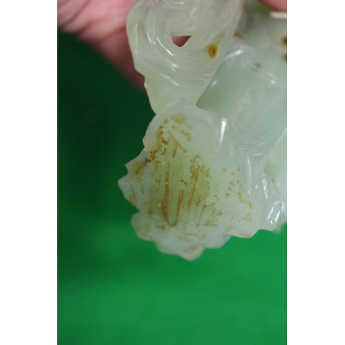 85 - A Chinese jade carving of Kuan-Yin, on wooden base, 8 1/2