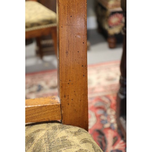 409 - A set of four early 19th century fruitwood dining chairs with swag carved vertical rail backs and st... 