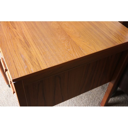 567 - A 1960s teak double pedestal desk, fitted one deep and three shallow drawers, on stile supports, 59