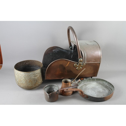 129 - A 19th century copper coal shute, a copper frying pan, two measures, a warming pan, an Indian brass ... 