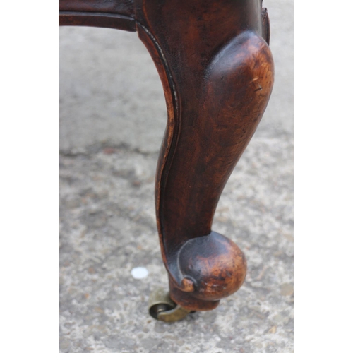 402 - A 19th century mahogany showframe chair, button upholstered in a blue velour, on cabriole supports, ... 