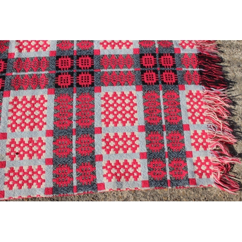 173 - A Welsh wool blanket with geometric design in shades of pink, black and natural, 75