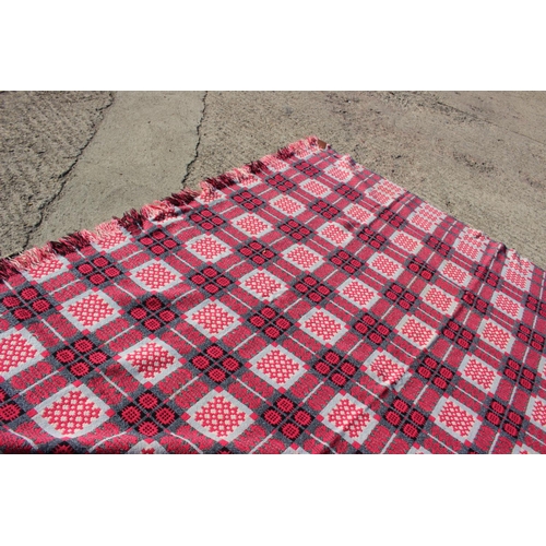 173 - A Welsh wool blanket with geometric design in shades of pink, black and natural, 75